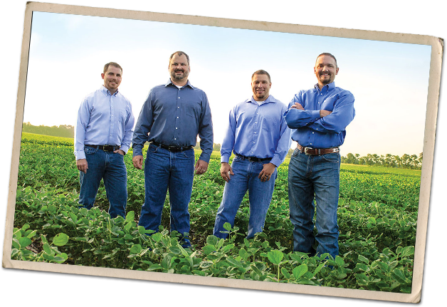 photo-ag_team-628x431 Four men standing in a field.