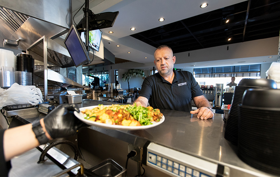 Alex preparing to deliver food at a Meddys location